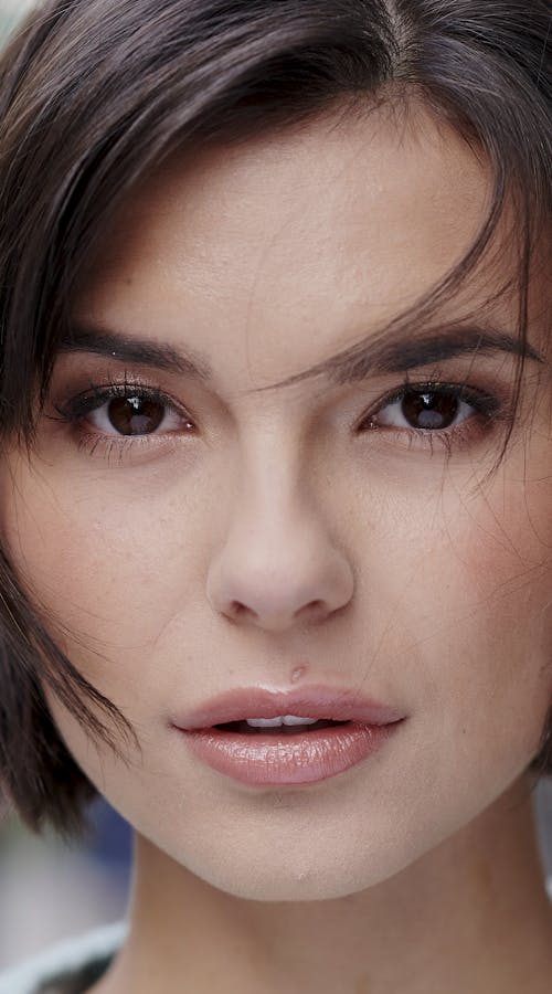Close up of curly dark haired girl with brown eyes