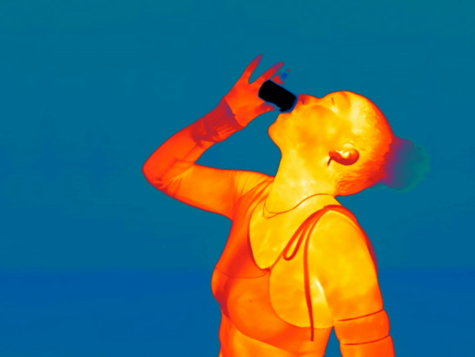 a clubgoer drinking a shot of jagermeister in infrared