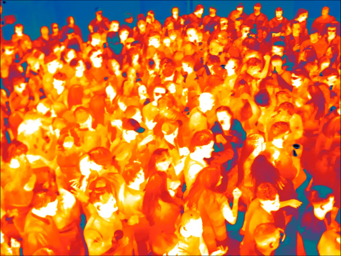 wide shot of many clubgoers in infrared