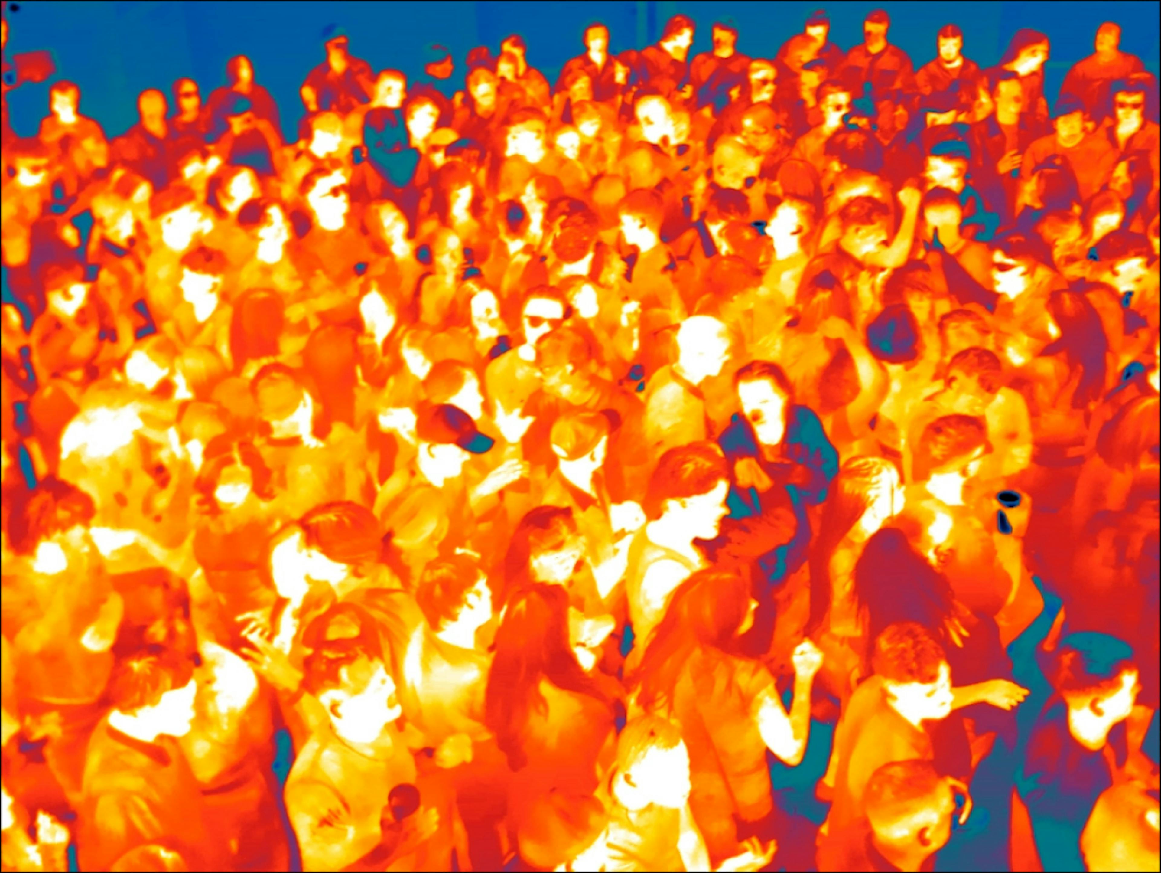 wide shot of many clubgoers in infrared