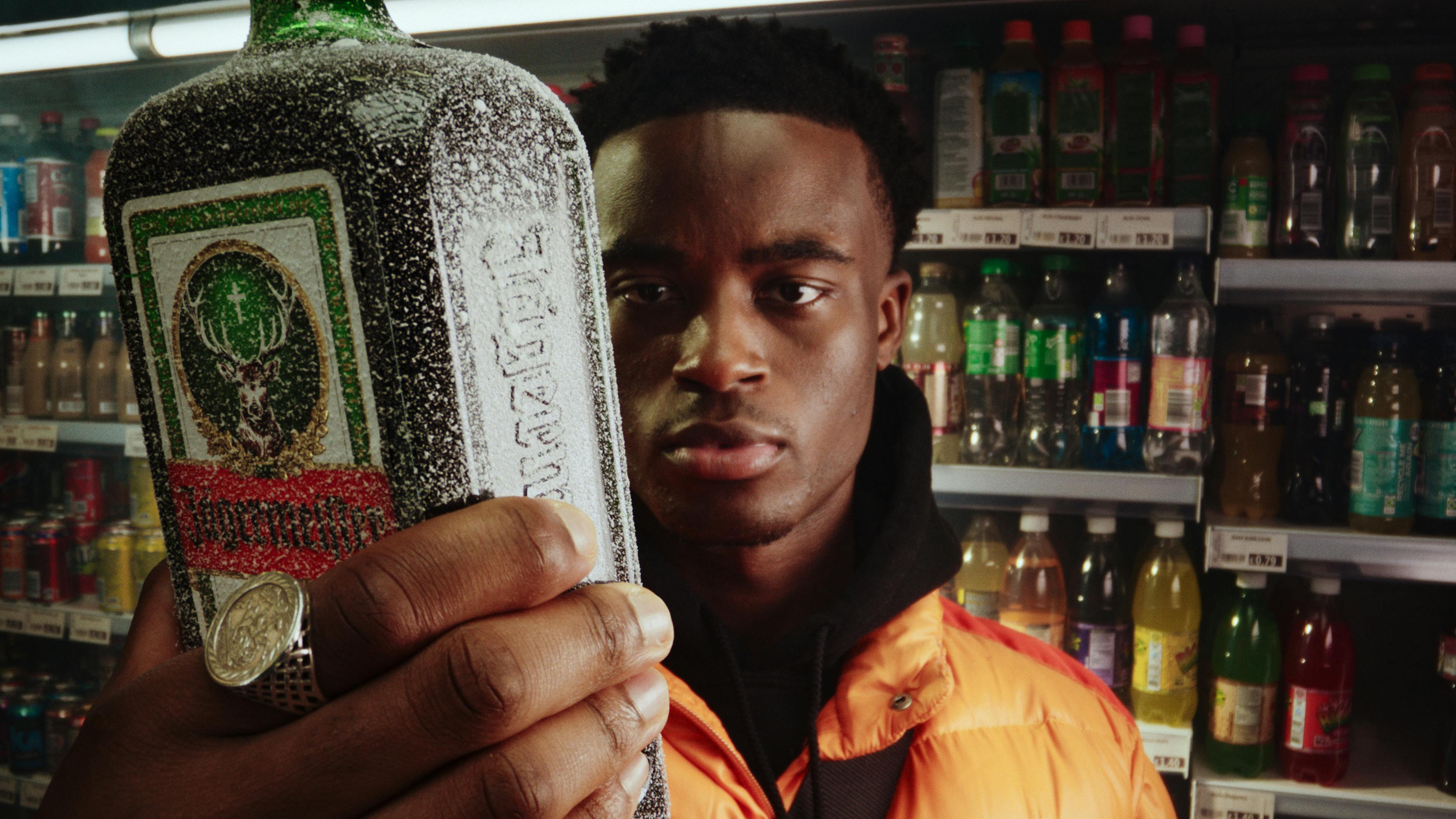 Man holding Jägermeister bottle in a shop