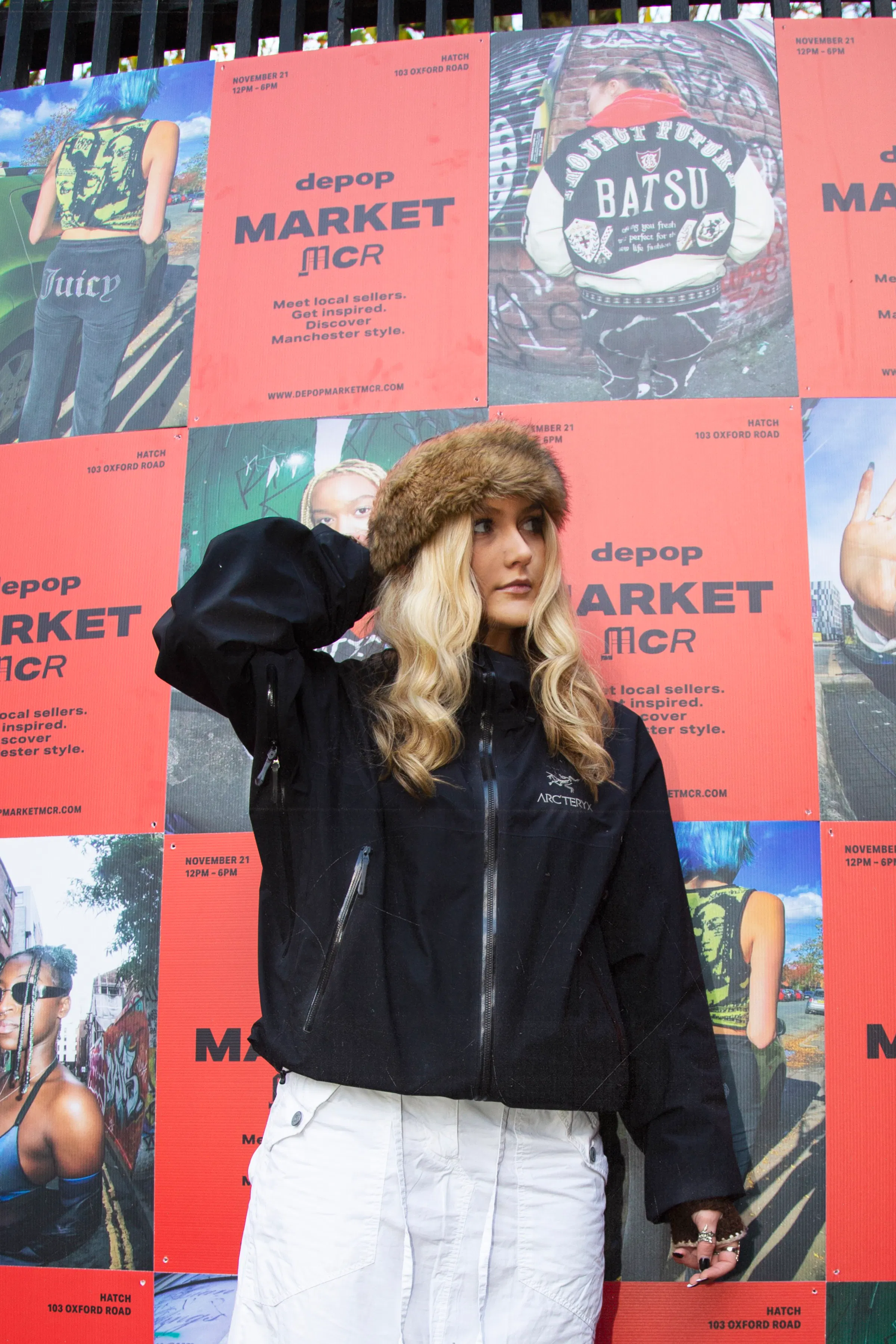 SBA standing in front of depop posters