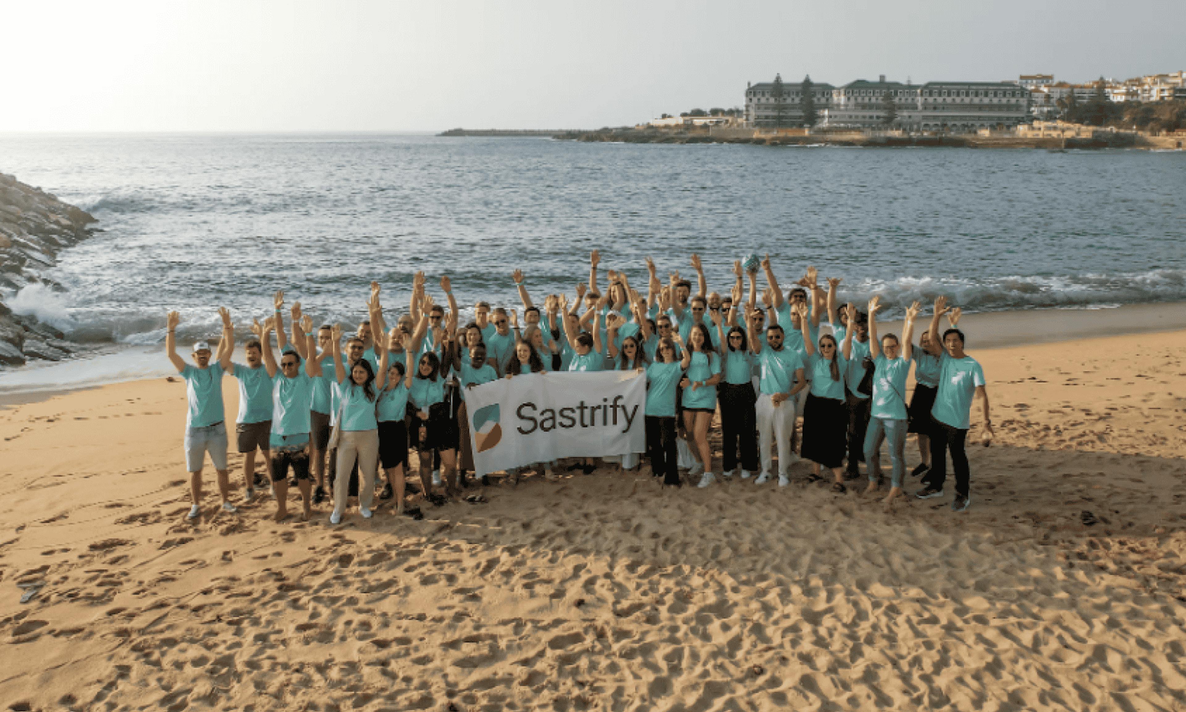 sastrify workers taking photo on beach