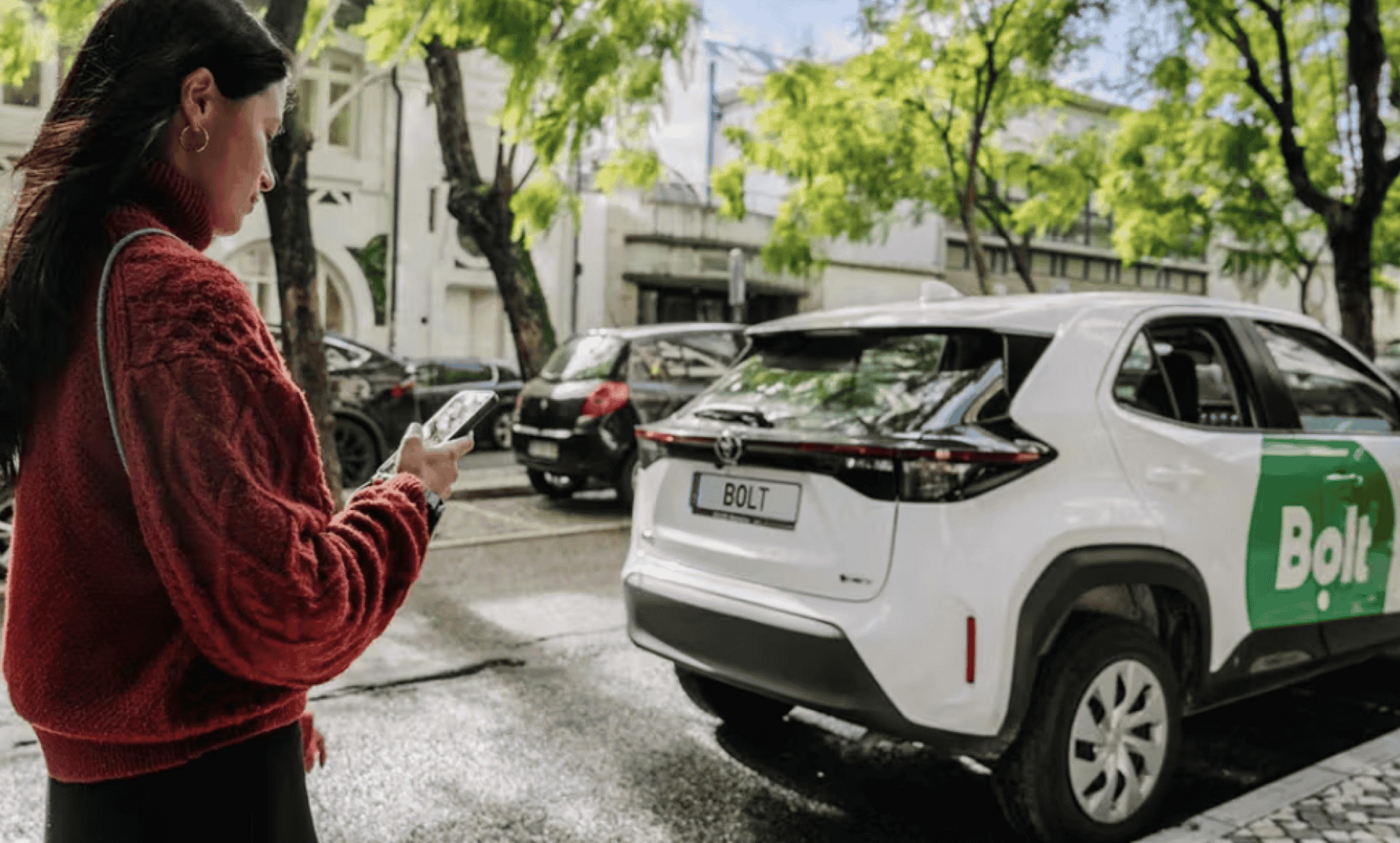pedestrian walking past bolt car