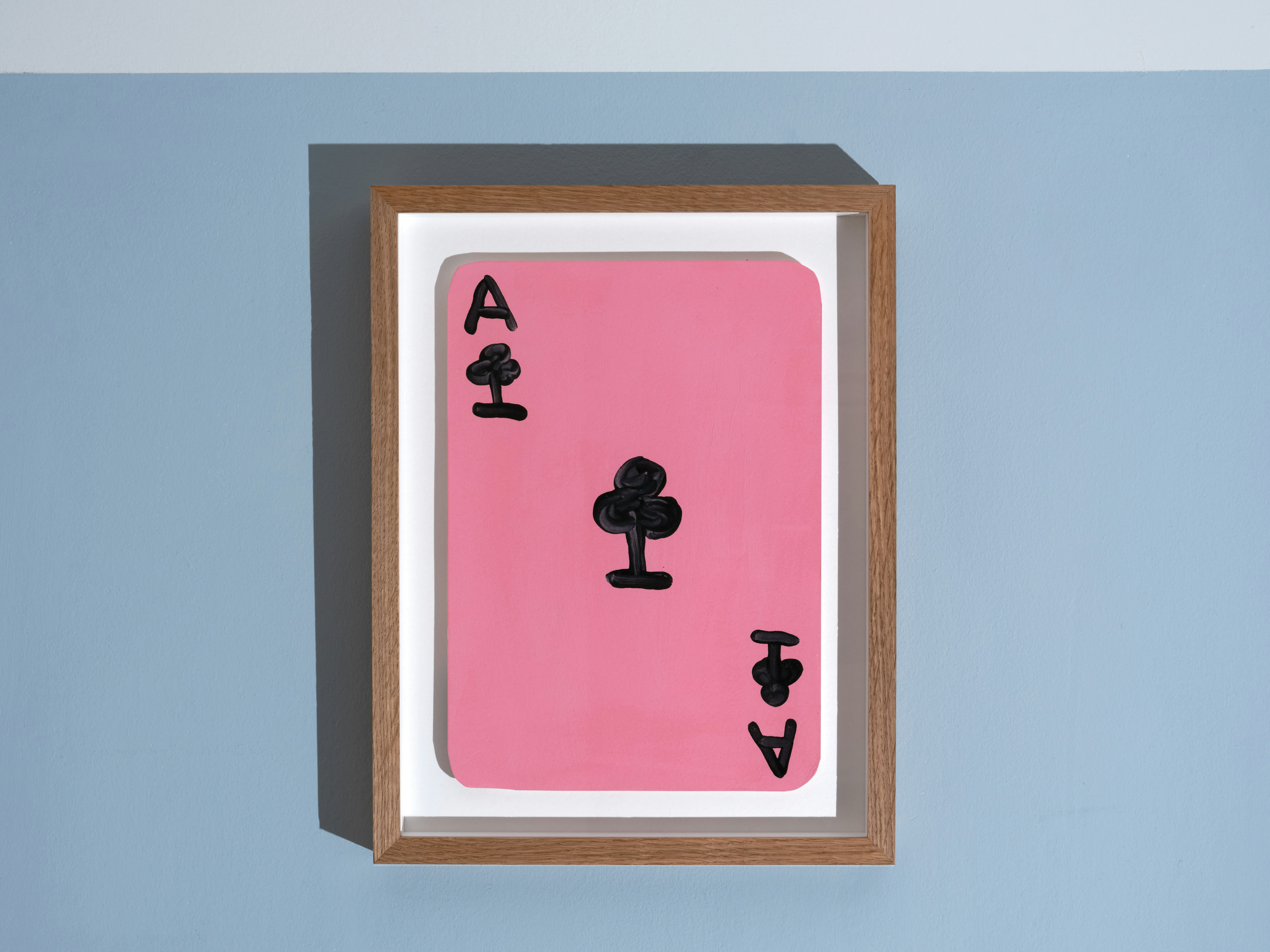 installation photo of framed paint on card by David Shrigley depicting ace of clubs card 