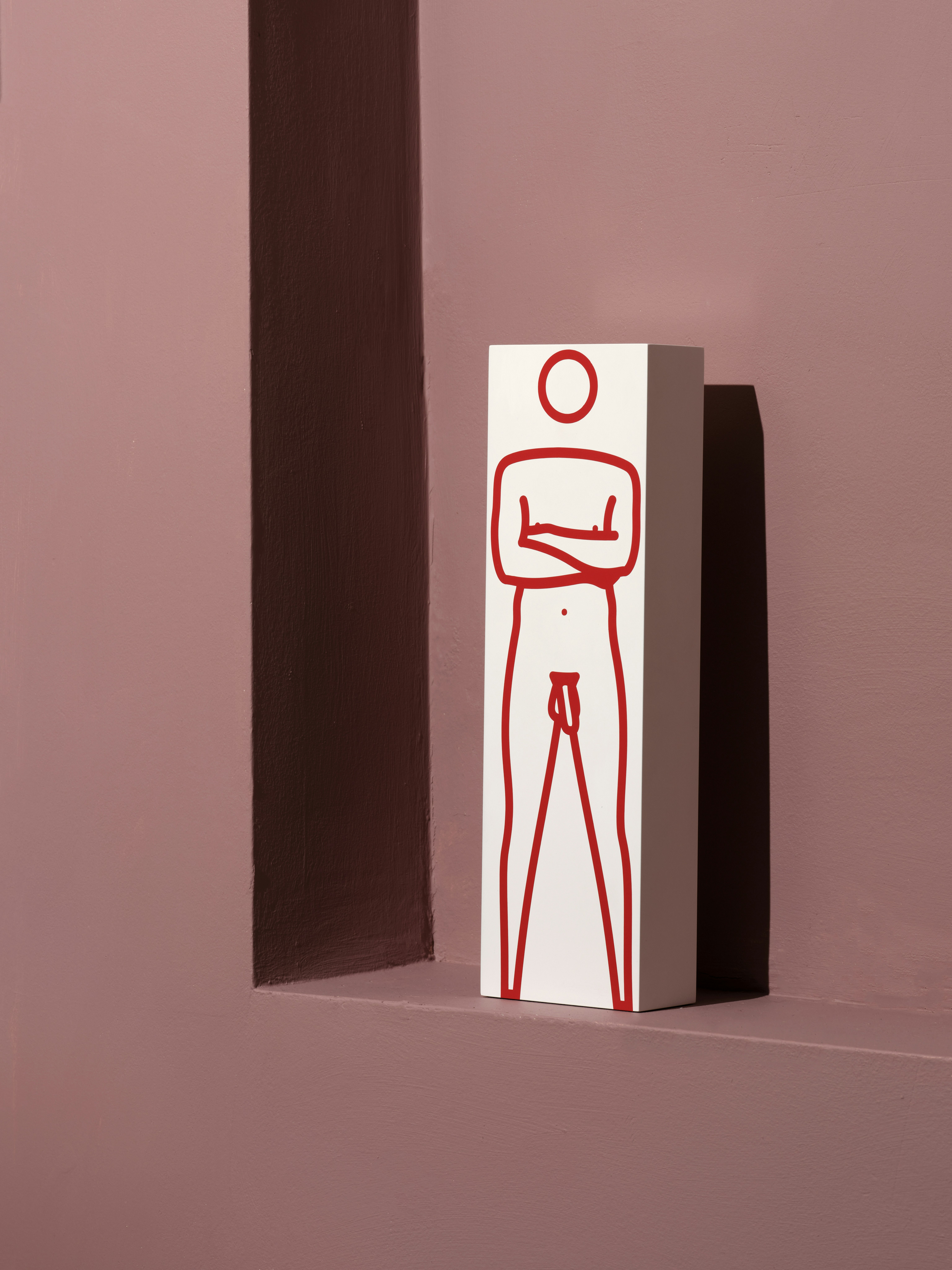 Paint and vinyl on white wood depicting naked man with crossed arms in red