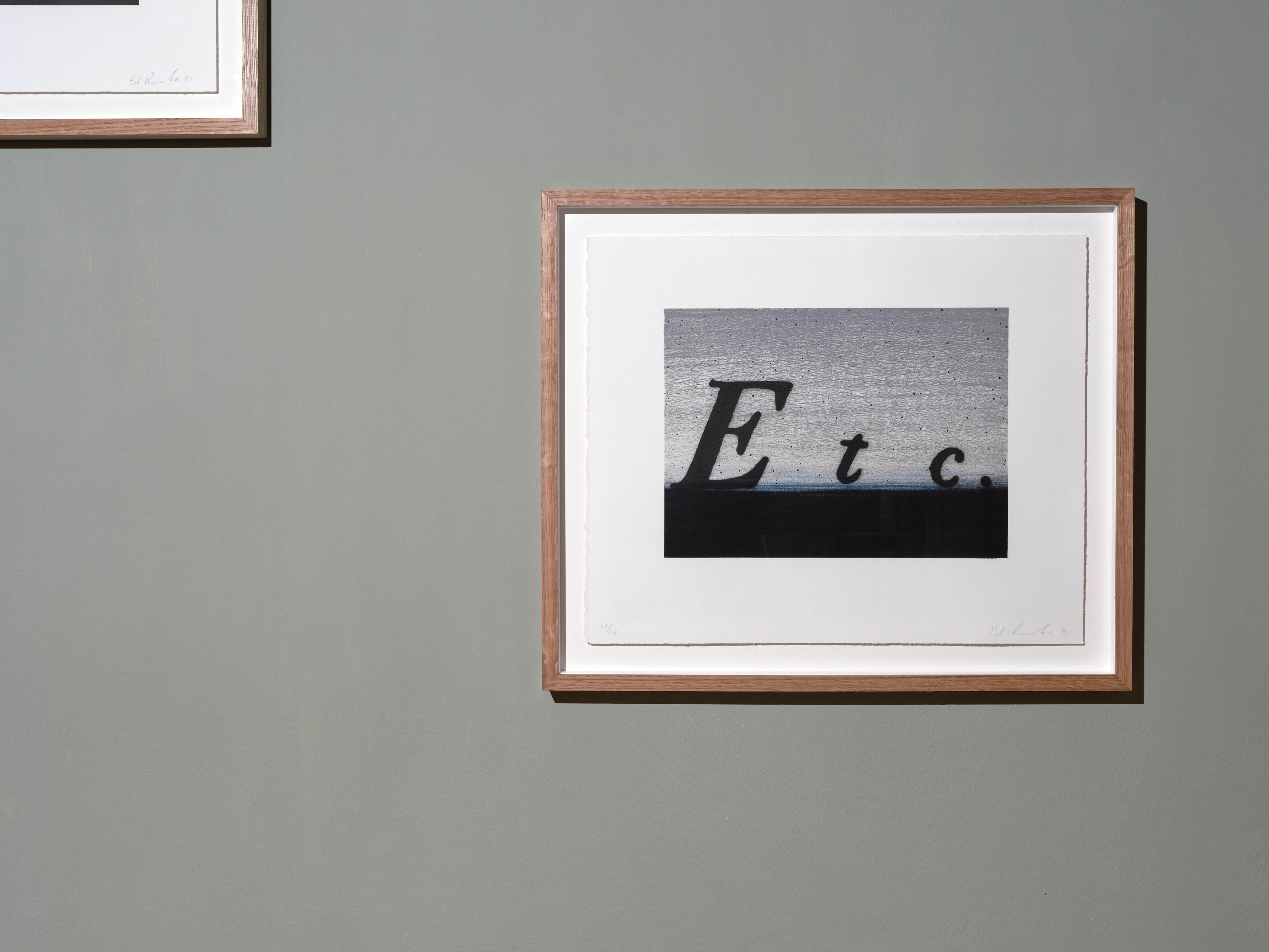 installation photograph of framed lithograph in colours by Ed Ruscha with phrase Etc. in black