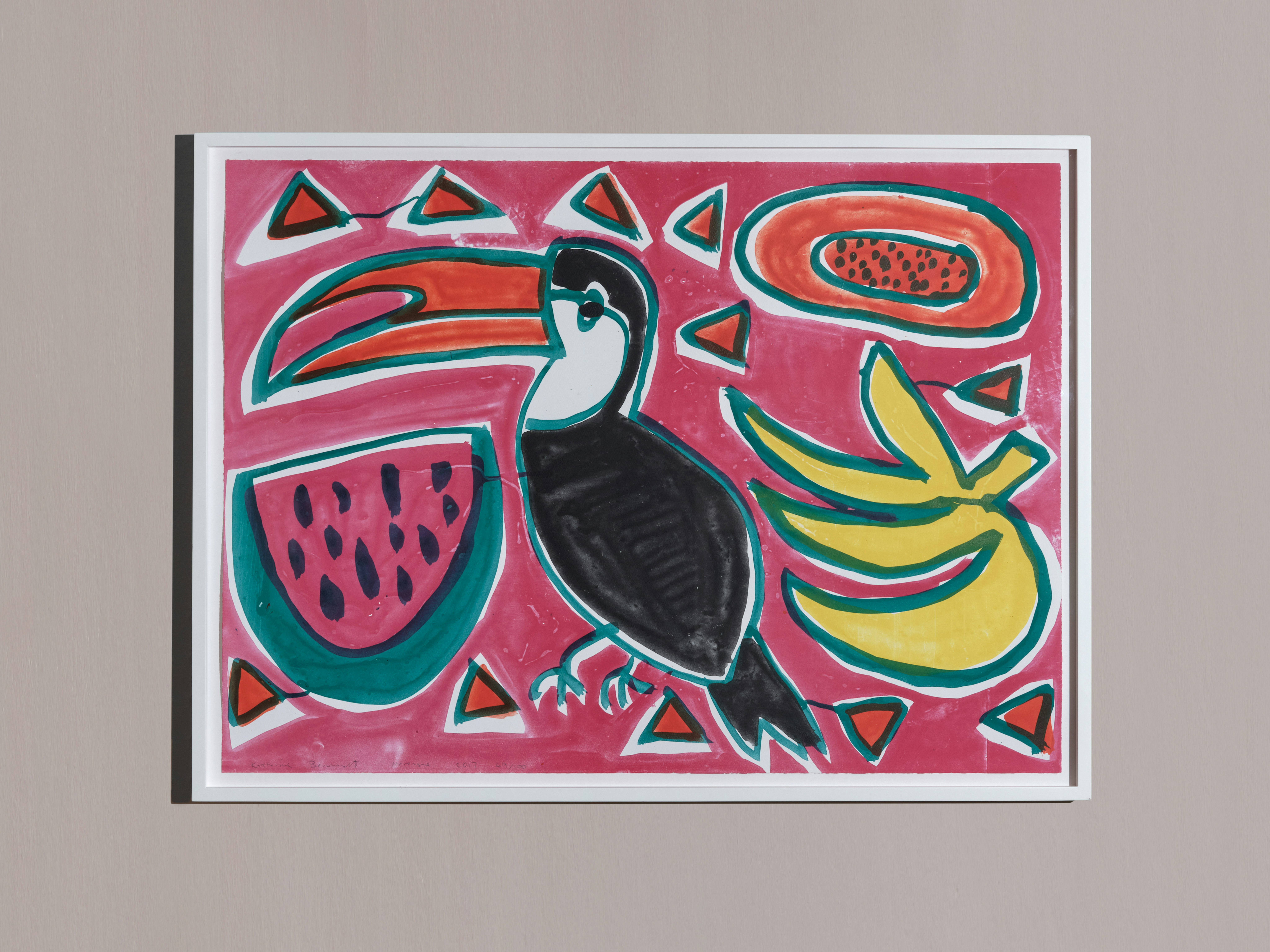 Installation photo of framed lithograph by Katherine Bernhardt depicting toucan, papaya, slice of watermelon, bananas on hot pink background
