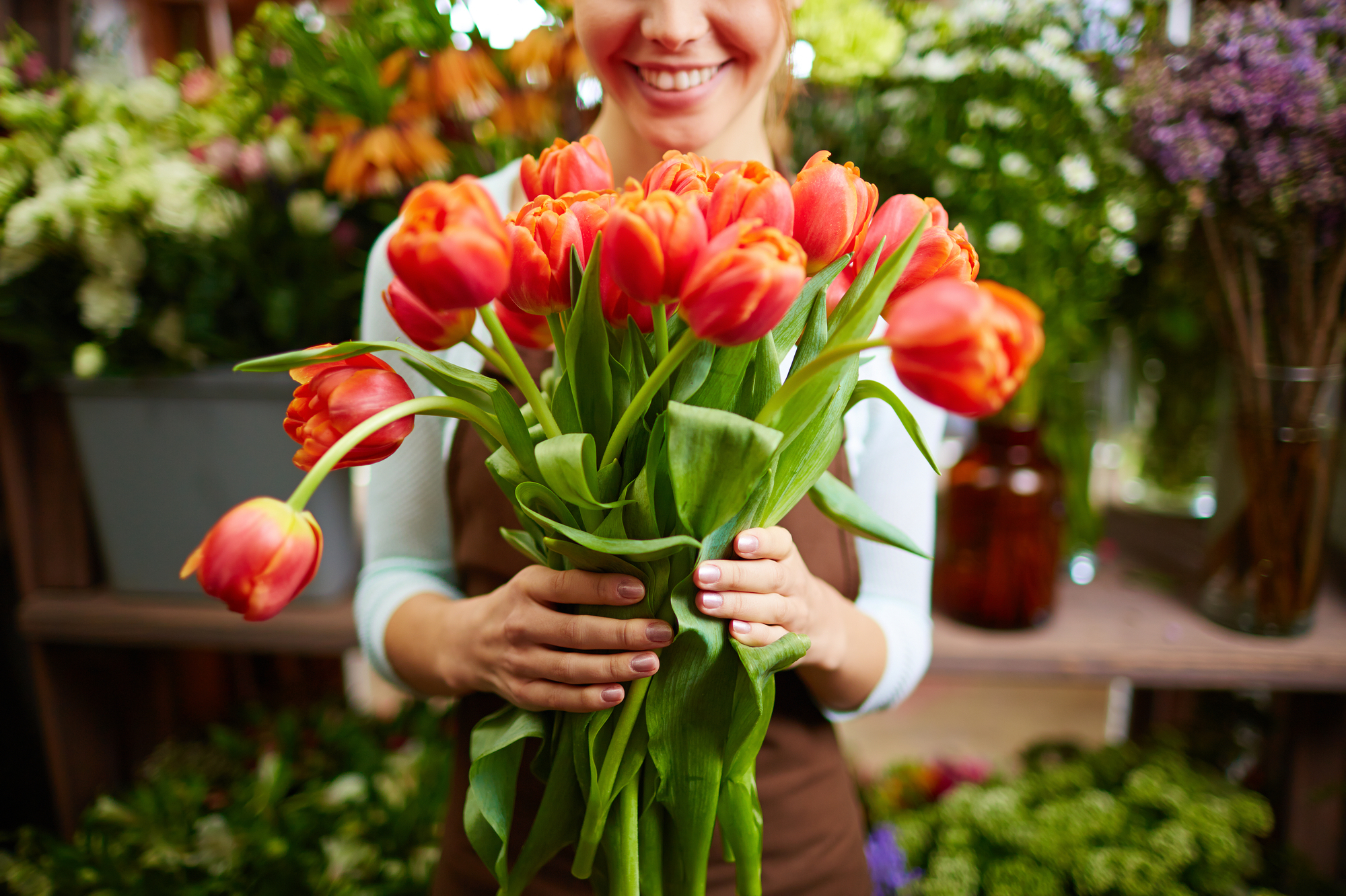 Bloemiste met groot boeket oranje tulpen