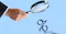Animated Image of man holding magnifying glass