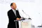 man giving speech on stage