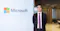 Man standing in front of Microsoft board