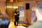 A man in a suit speaks at a microphone in front of two FinCity.Tokyo banners at an indoor event. He is holding papers and addressing an audience.