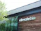 Exterior view of an ElevateBio building with wood siding, large reflective windows, and the company logo displayed on the facade.