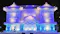 The image depicts an intricately designed snow sculpture of a traditional building, illuminated with blue and purple lights. The structure showcases detailed architectural elements such as ornate roofs and columns, typical of East Asian architecture. This type of snow sculpture is often seen at winter festivals, where artists create large-scale artworks from snow and ice.