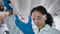 Lab worker with beaker in a lab
