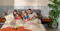 family in bed reading and eating