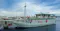 Doctor share medical boat in a harbour with blue water