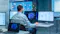 A person in business attire is working at a desk with dual monitors displaying various data analytics dashboards. The screens show charts, graphs, maps, and performance metrics, indicating the individual is analyzing financial, sales, and operational data to gain insights and support decision-making.