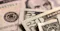 The context appears to be related to money, finance, or economics. The image shows close-up views of U.S. dollar bills, suggesting topics such as currency, banking, financial transactions, or economic policy.