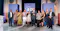 Group of 10 award recipients pose on stage at the .org Impact Awards 2025, holding glass trophies in front of blue event signage in a grand columned venue.