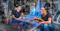 Two engineers review a large industrial component in a factory, using a digital 3D model overlay and a handheld scanning device.