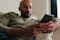 Person sitting on a sofa using a smartphone indoors