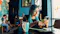 female having coffee in a cafe looking at her phone