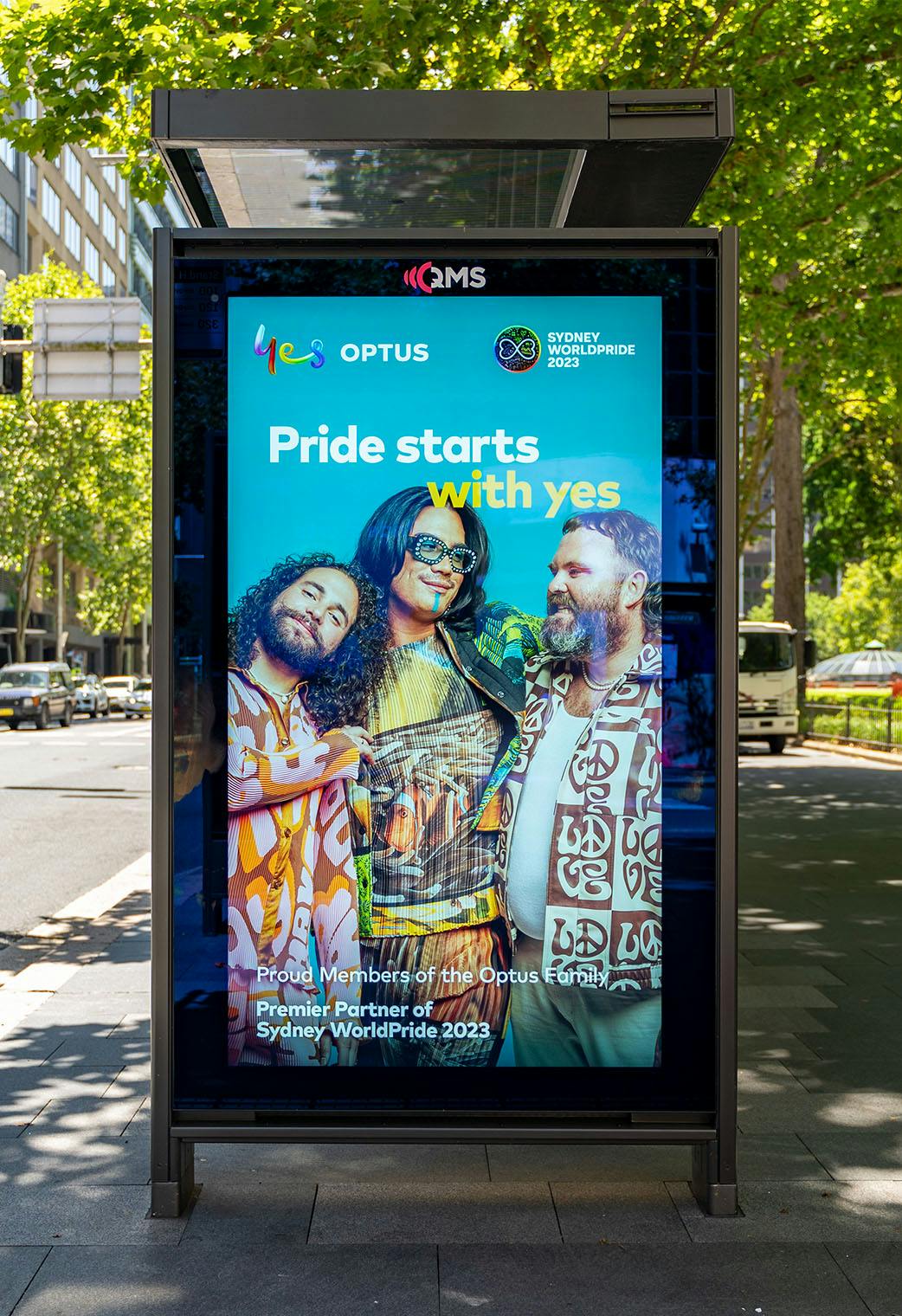 A photo of a street furniture placement in the CBD featuring the Optus x SydneyWorldPride campaign: Pride starts with yes