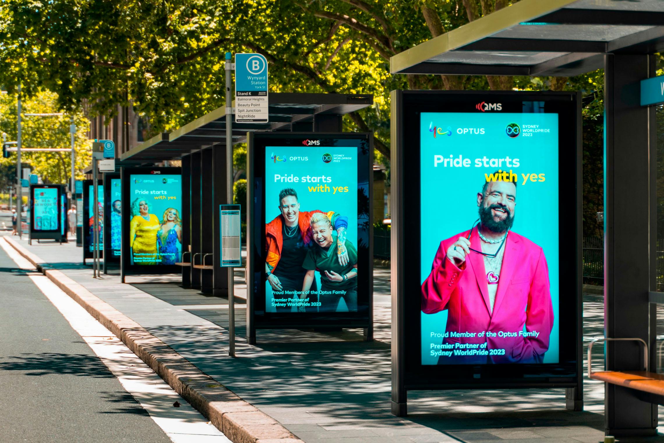 A photo of consecutive street furniture placements in the CBD featuring the Optus x SydneyWorldPride campaign: Pride starts with yes