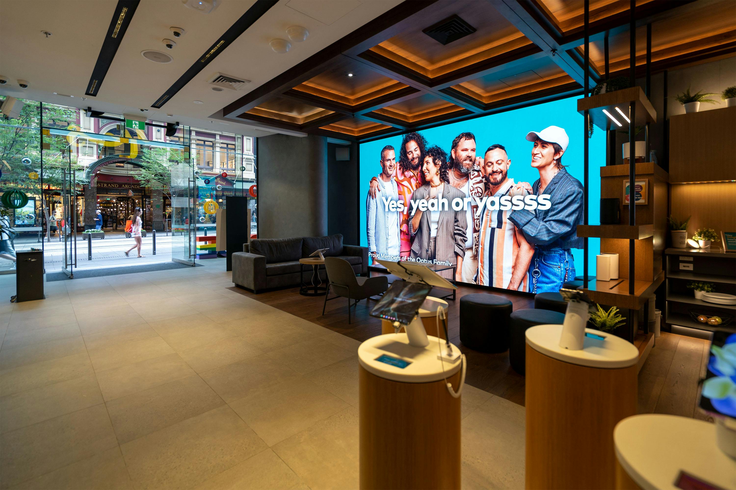 A photo of the Optus George Street Sydney store interior featuring the Optus x SydneyWorldPride campaign: Pride starts with yes