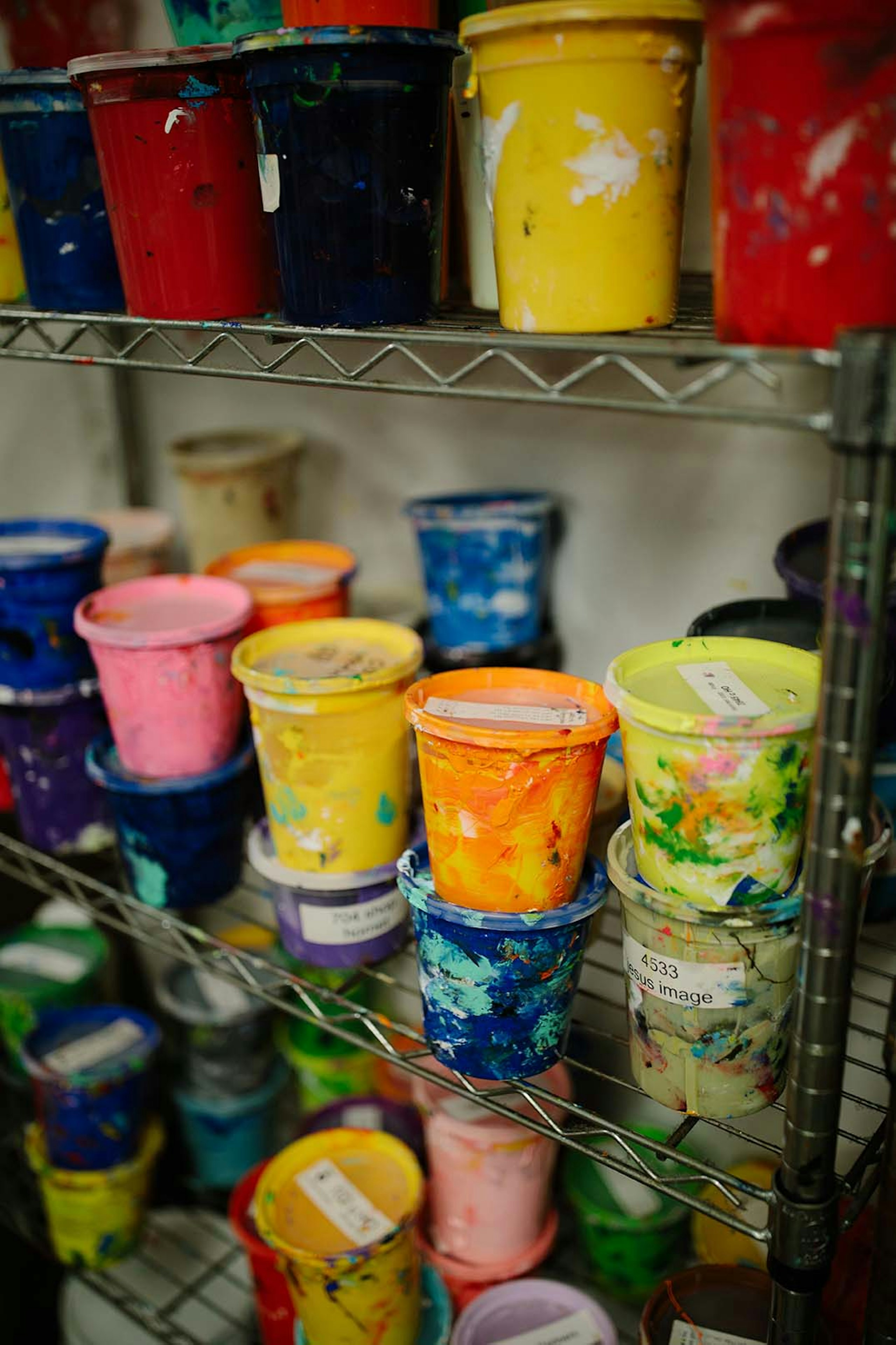 a shelf full of containers of ink