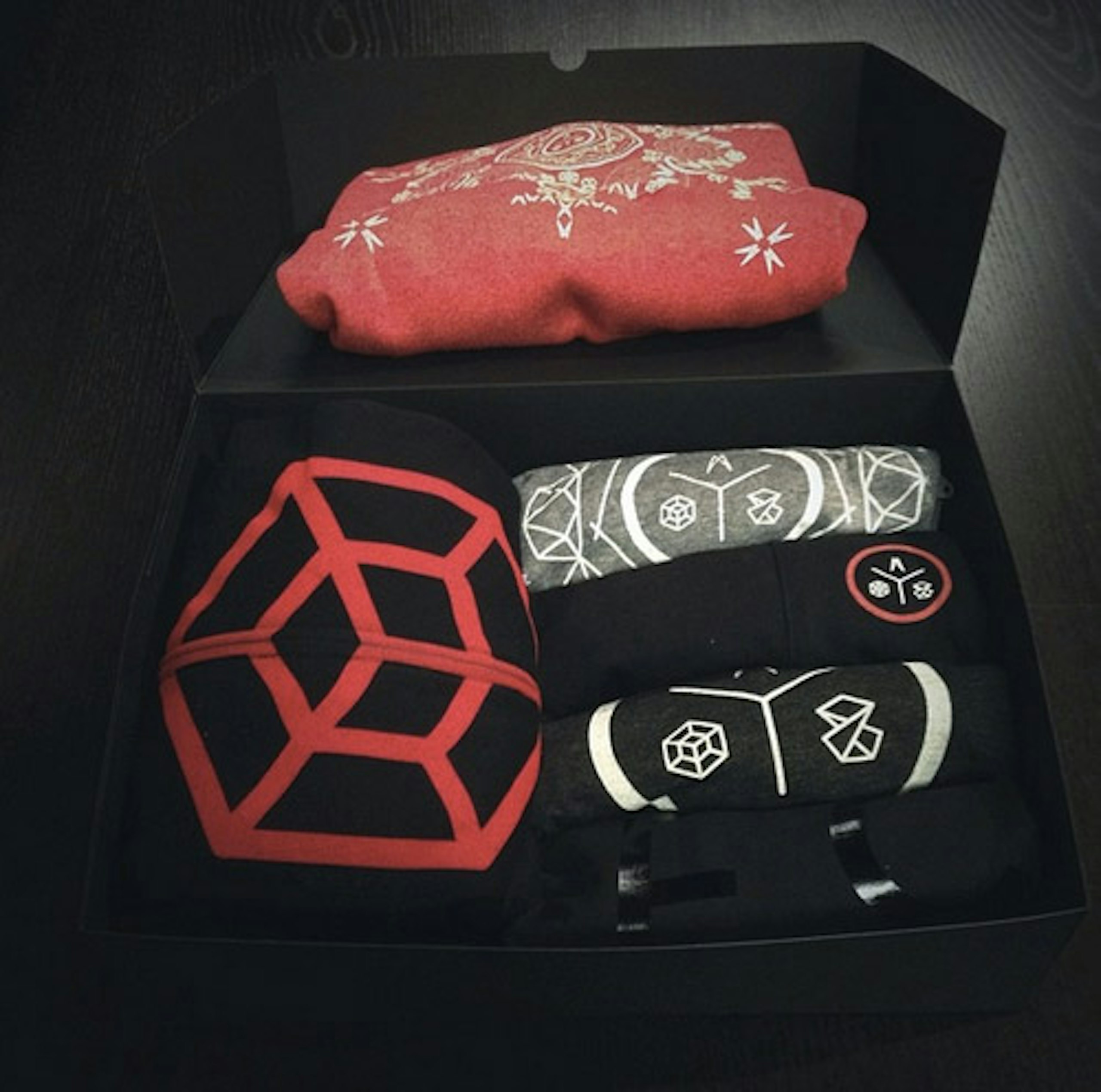 merch box with zip-up hoodie and t-shirts