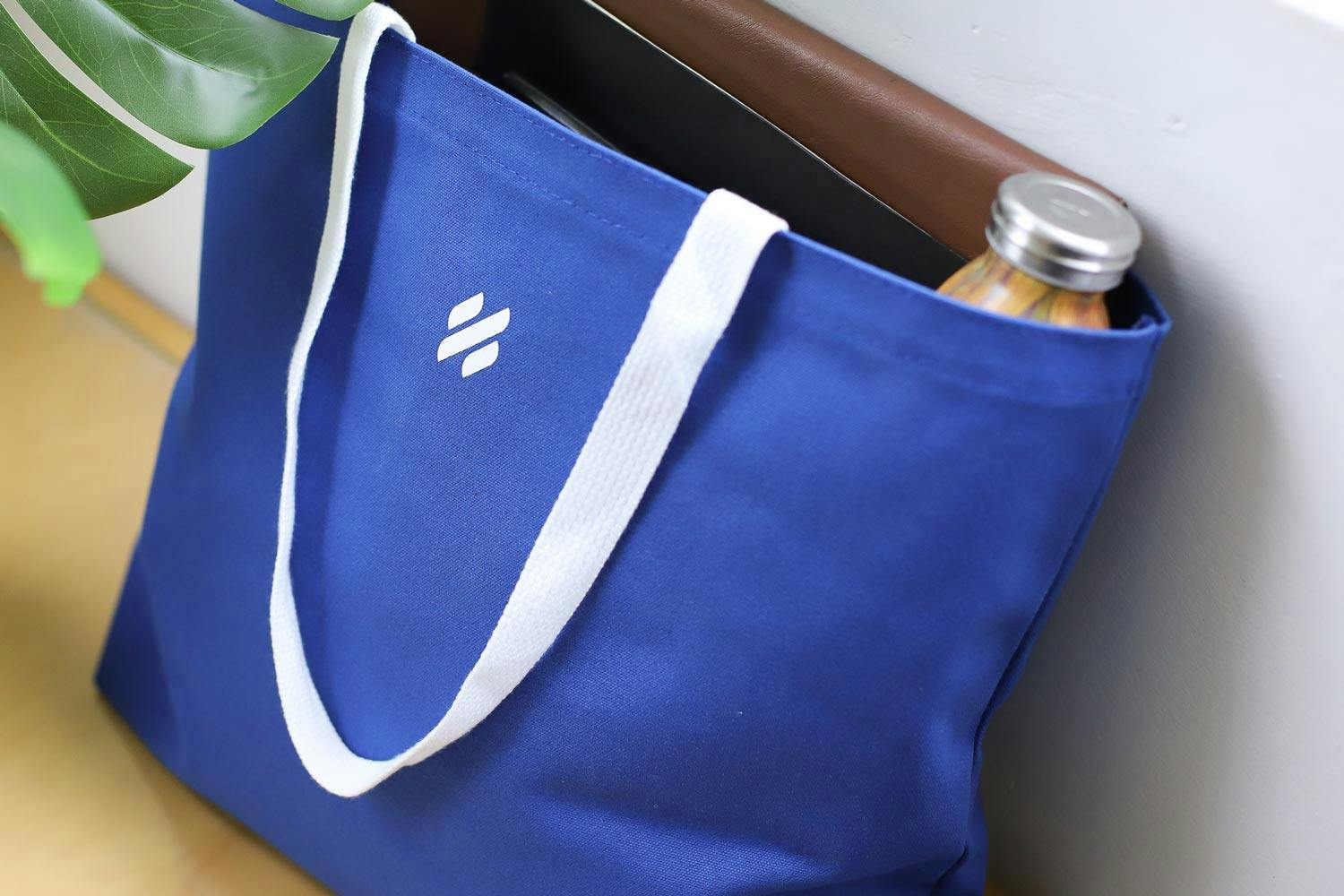 blue tote bag this help scout logo icon printed on it in white