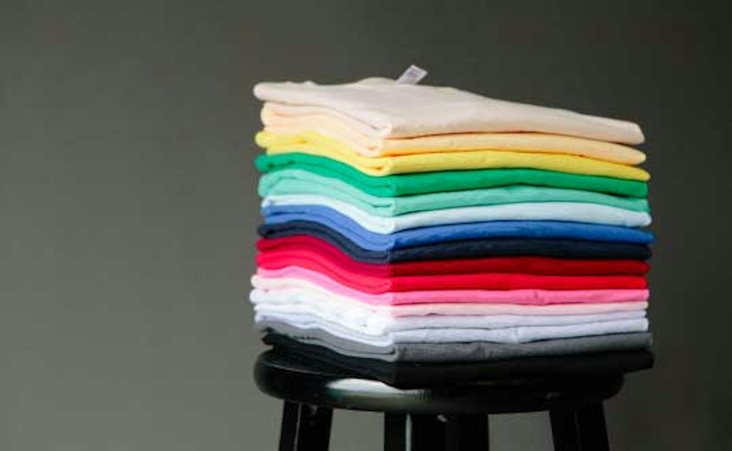 stack of shirts on a stool
