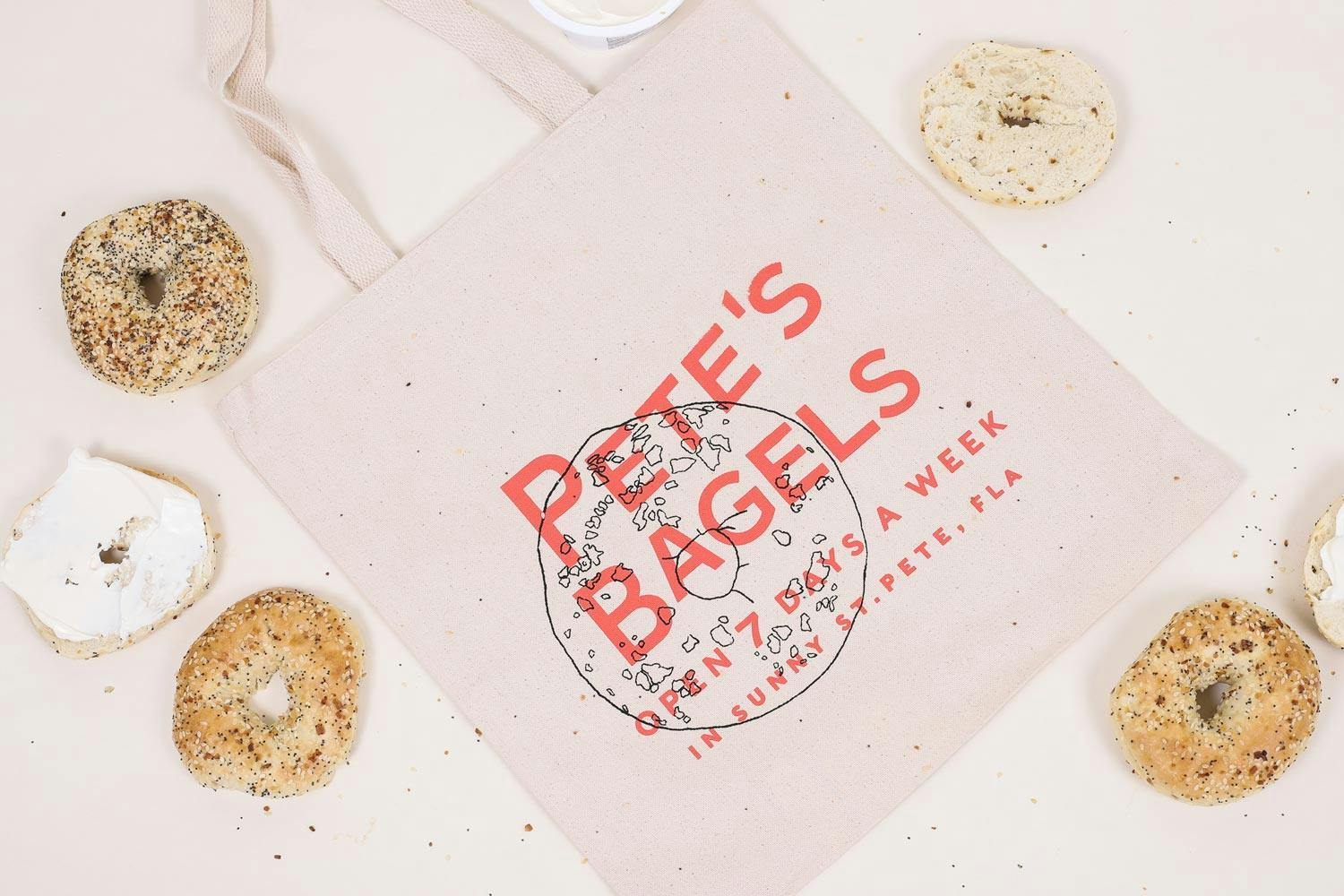 pink tote with bagels around it