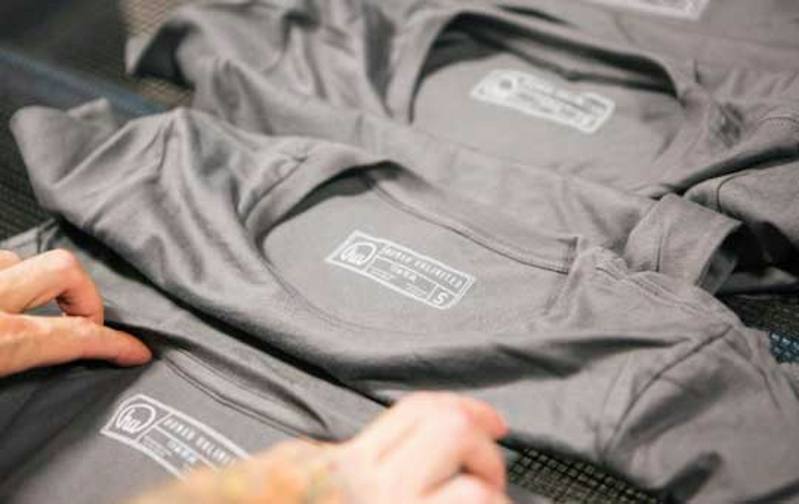 gray shirt with printed tags