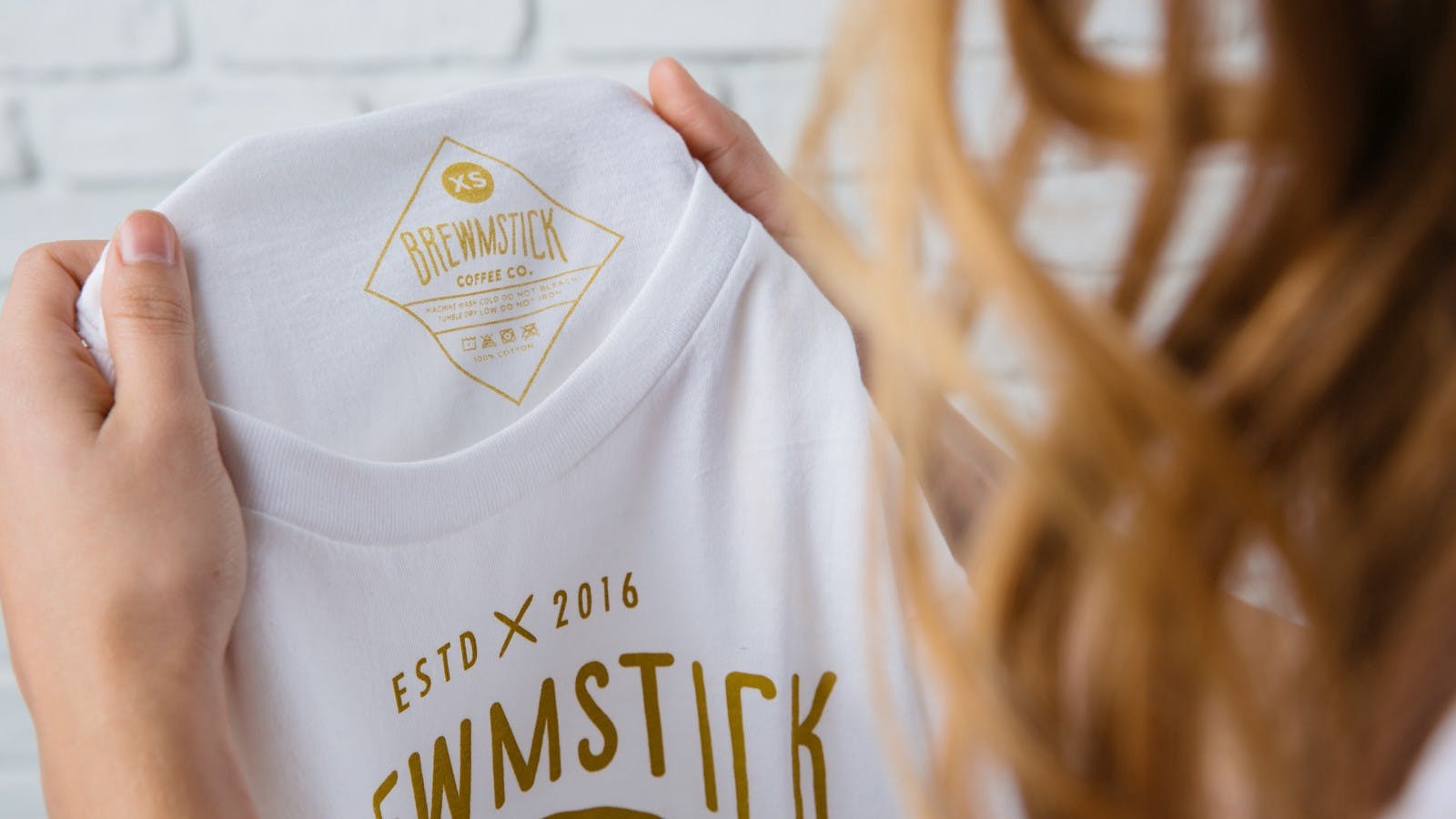 white t-shirt with gold color tag printing