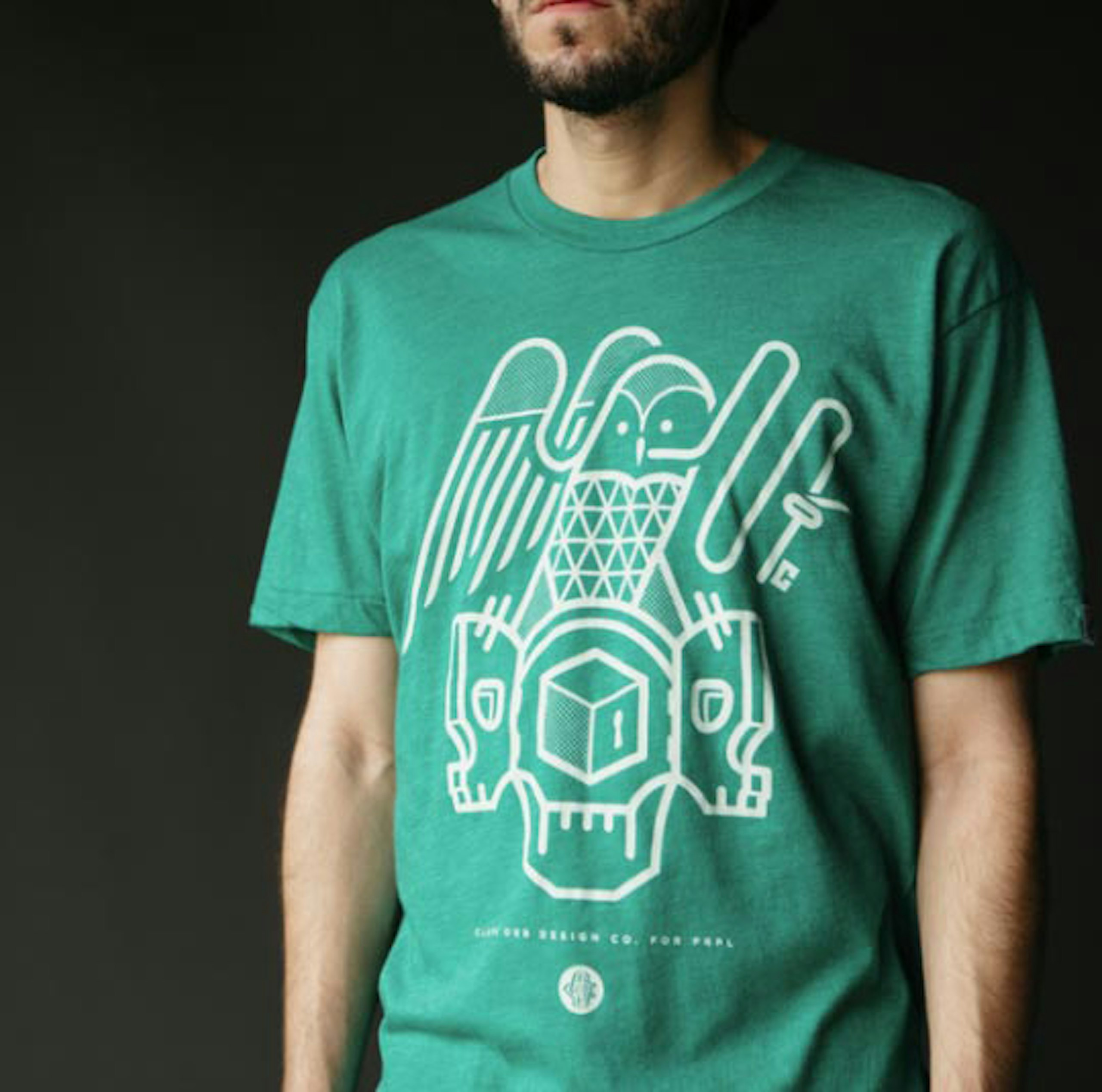 man standing with green shirt with white owl graphic