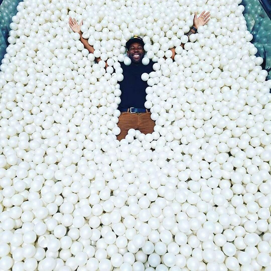 person in an all white ball pit person in an all white ball pit