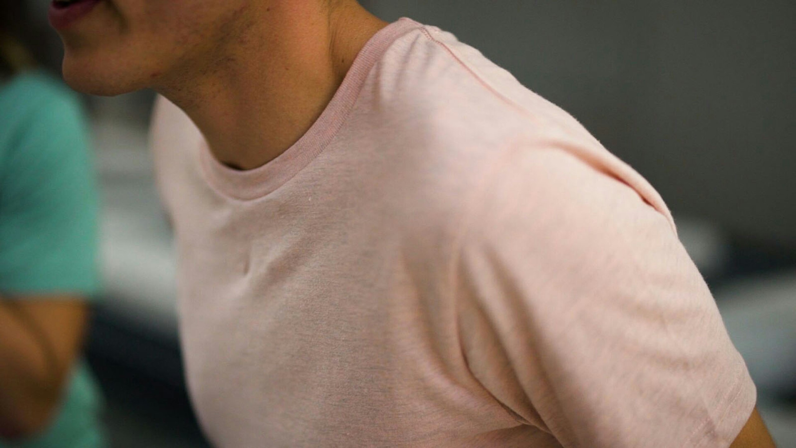 man wearing a heather peach shirt
