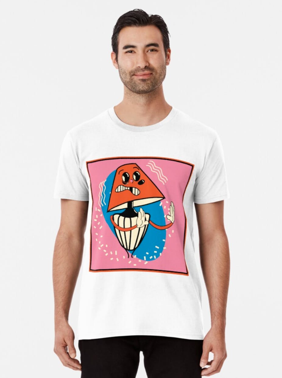A man models a graphic t-shirt with a cartoon lamp on it A man models a graphic t-shirt with a cartoon lamp on it