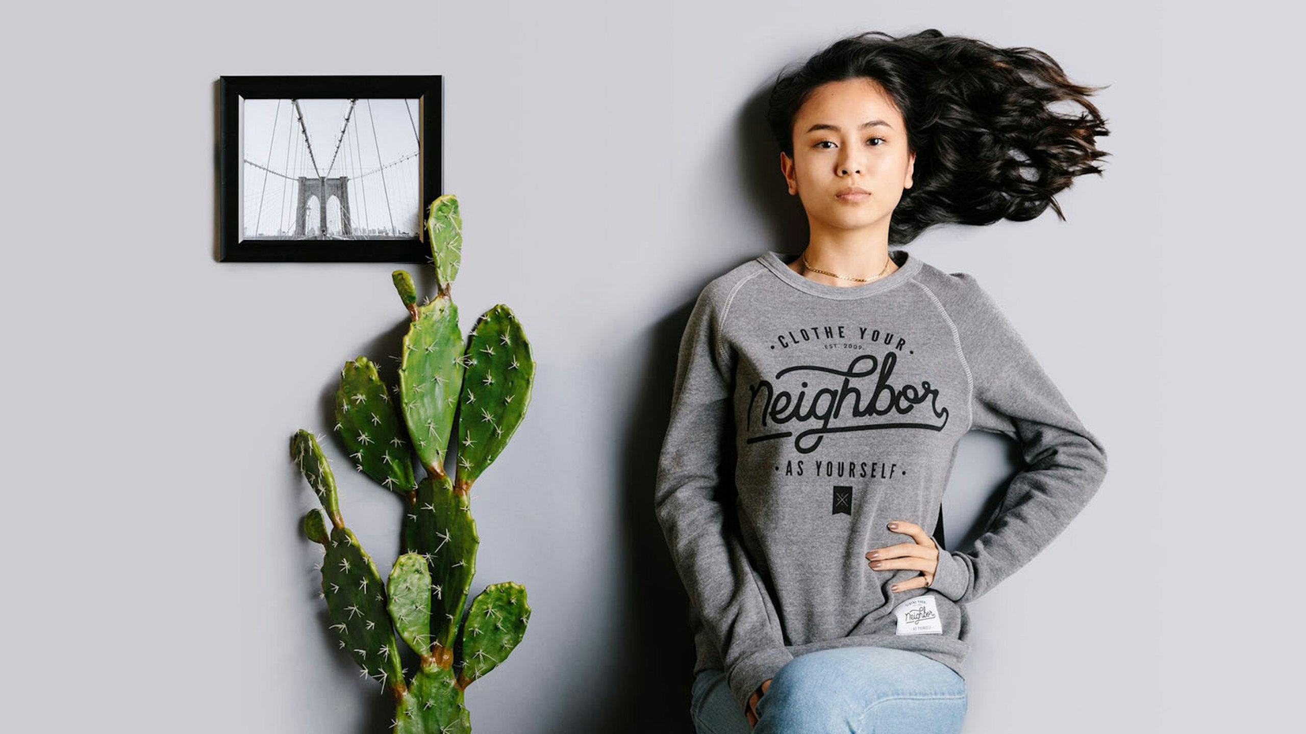 women wearing a dark gray crewneck sweatshirt