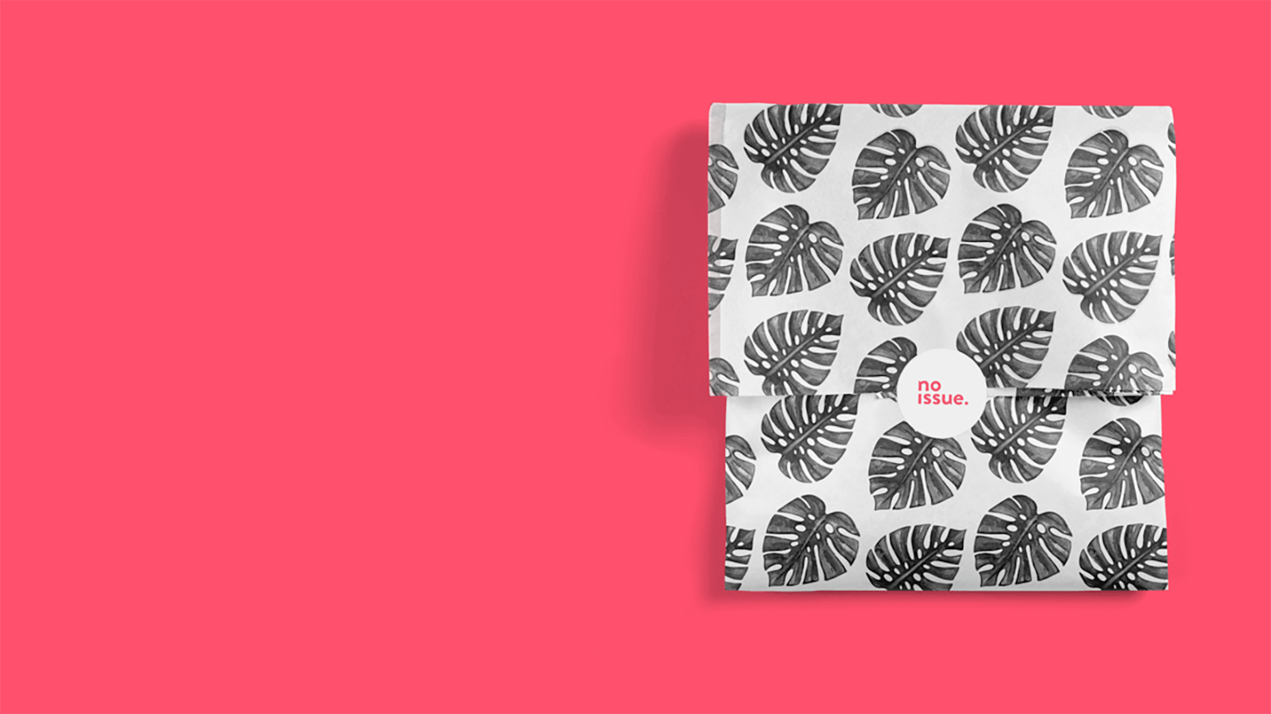 gray leaf wrapped package on a hot pink background