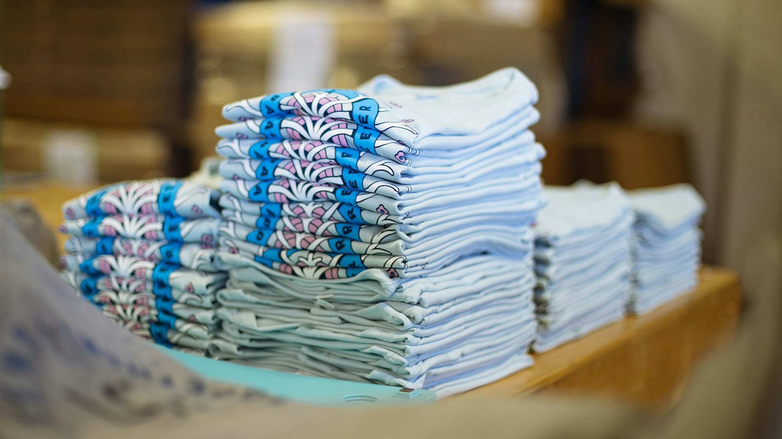 multiple stacks of t-shirts