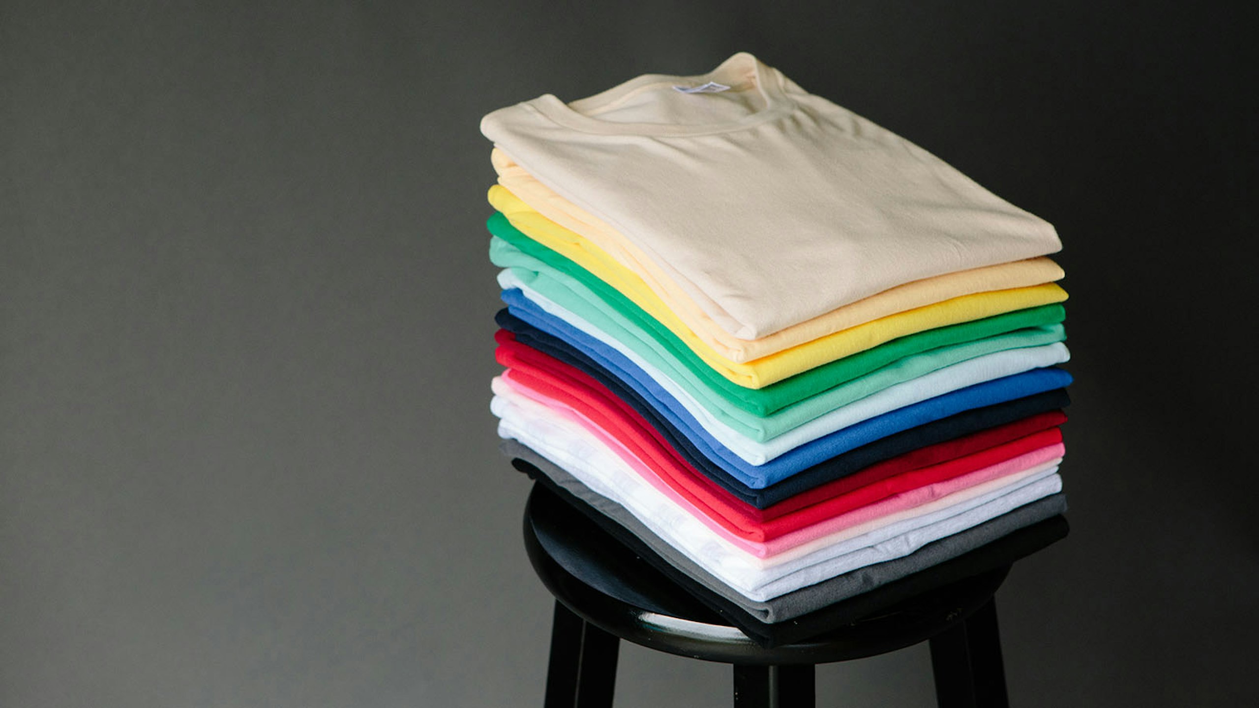 stack of shirts on a stool