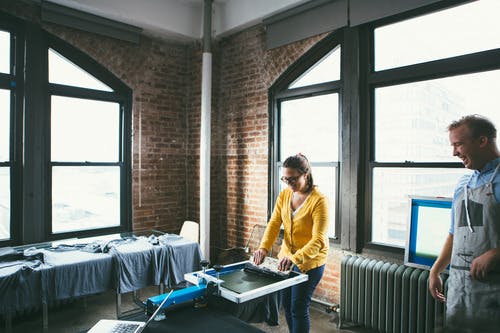 woman in yellow screen printing woman in yellow screen printing