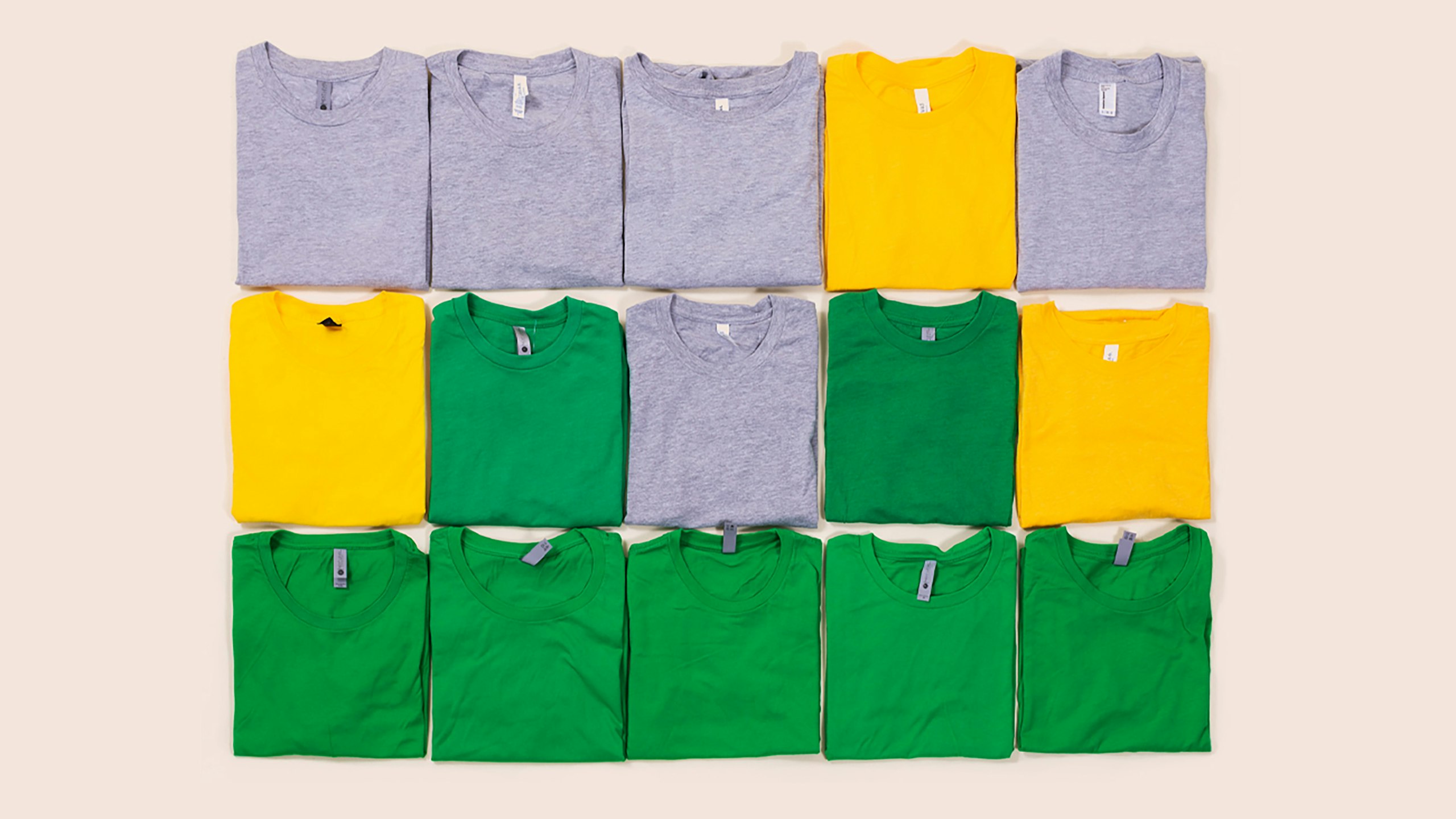 t-shirt placed like a wordle board. row 1: gray, gray, gray, yellow, gray - row 2: yellow, green, gray, green, yellow - row 3 all greens