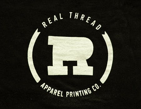 old real thread logo on black fabric old real thread logo on black fabric