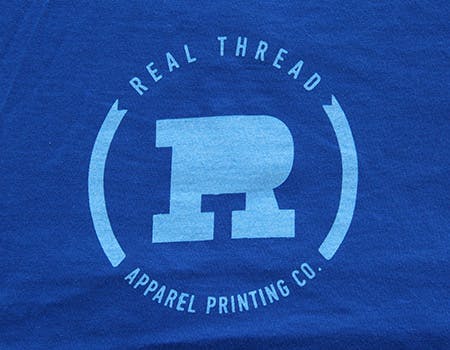 old real thread logo on blue fabric old real thread logo on blue fabric